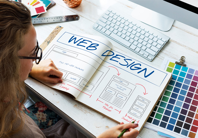 woman looking at web design book